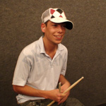 Photograph of Jonny holding sticks